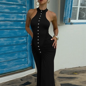 Detalle de vestido ceñido negro con botones blancos y elegante diseño plisado en la cintura