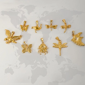Macro shot of 24K gold-plated animal pendants featuring butterflies and eagles