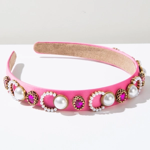 Detail of pink satin headband with white faux pearls and magenta gems in gold settings