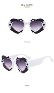 Front and side view of heart-shaped sunglasses with white frame and grey gradient lenses