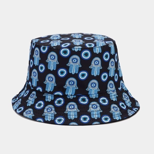 Detailed view of Hamsa and Evil Eye pattern stitching on black cotton bucket hat