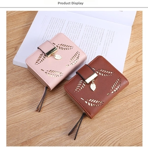 Close-up of hollow leaf pattern and tassel zipper on leather short wallets for women