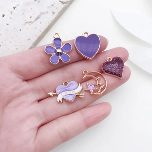 Handheld set of five purple enamel heart and flower alloy charms for DIY jewelry making