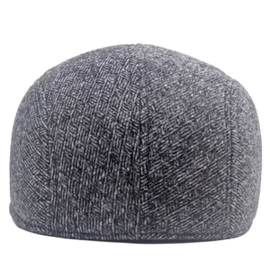 Detailed view of grey herringbone pattern on winter tweed flat cap for men