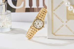 Close-up of square gold quartz watch with Roman numerals and diamond-set bezel