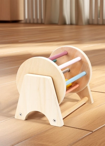 Close-up of wooden Montessori spinning drum with colorful bars for motor skills