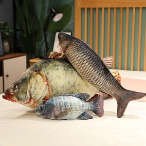 Realistic fish-shaped plush pillows in various sizes displayed on a cozy bedroom bed