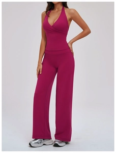 Detail of deep magenta yoga set featuring a halter V-neck top and high waist wide leg pants
