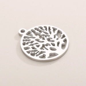 Detailed view of silver tree of life cutout pendant in polished stainless steel