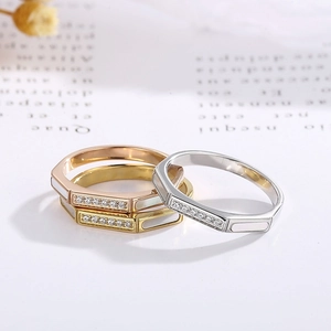 Detail of stacked octagonal rings in gold, rose gold, and silver with shell inlay and diamonds
