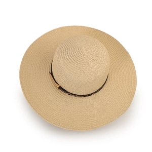 Detail of a beige wide-brim straw hat featuring a stylish leopard print ribbon and metal buckle