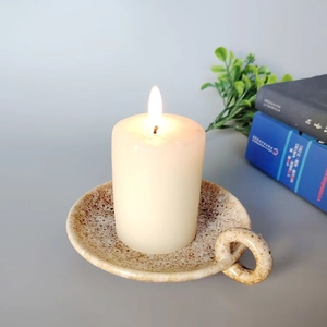 Minimalist modern cream ceramic candle holder with handle and textured brown speckles