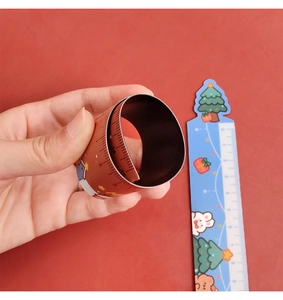 Cartoon Christmas snap ruler showing both straight and coiled states in 15cm scale