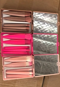 Three travel makeup brush sets with 5 pieces each and a built-in mirror case