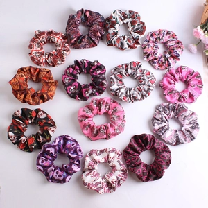Set of 14 oversized satin scrunchies with skull and rose patterns on white background