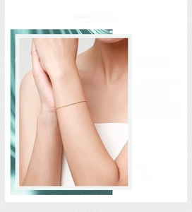 Close-up of minimalist gold snake chain bracelet on wrist featuring polished metallic finish
