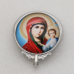 Detailed macro view of an Orthodox Virgin and Child religious icon in a silver metal frame