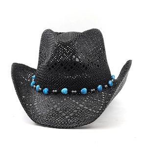 Detail of hand-woven black straw cowboy hat featuring blue marble heart beads