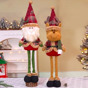Detail of Christmas plush gnomes with plaid outfits standing by a warm holiday tree