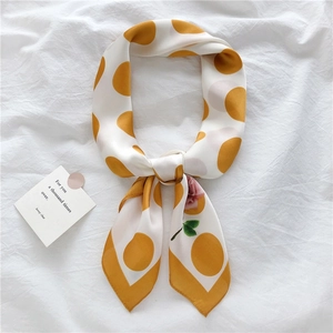 Detail of satin floral scarf with yellow polka dots and pink roses on white silk