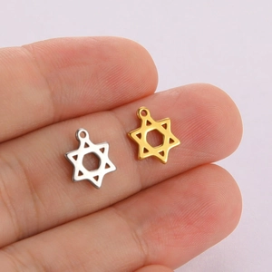 Star of David pendants in gold and silver steel finish held on fingertips for scale