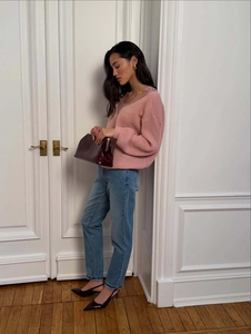 Detailed lace trim on V-neck pink knit cardigan with elegant street style accessories