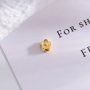 Macro shot of gold floral spacer bead with matte finish for DIY jewelry making