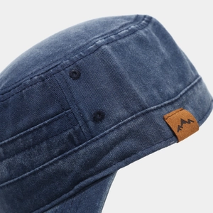 Close-up of navy washed cotton military cap with mountain leather patch and eyelets