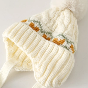 Winter knit baby earflap hat with heart jacquard patterns and a soft faux fur pom-pom