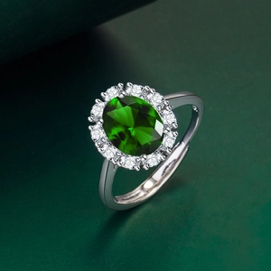 Oval green gemstone ring with halo crystal setting and adjustable silver band