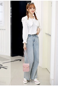 Pink crocodile pattern shoulder bag with gold clasp paired with a lace shirt and jeans