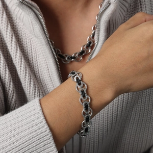 Men's titanium steel chain bracelet in silver and black shown on model's wrist