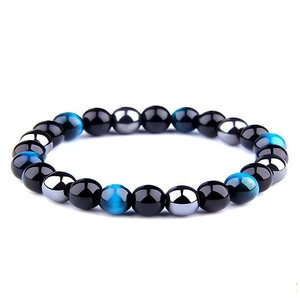 Detail of 8mm hematite and tiger eye energy beads on a polished yoga bracelet