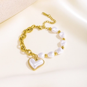 Macro view of baroque heart pearl splicing gold chain bracelet with adjustable clasp