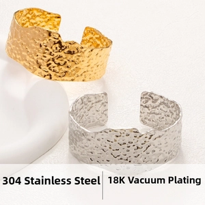 Detail of 304 stainless steel textured wide cuff bangles with 18K gold and silver plating