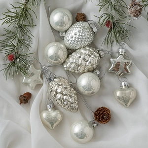 Silver and pearl white Christmas ornaments set with pine cones on white fabric