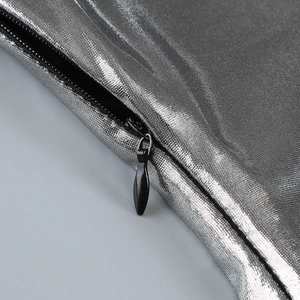 Detailed macro view of invisible black zipper on metallic silver coated fabric dress