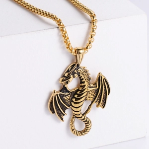 Retro punk dragon pendant necklace in vintage gold finish shown on studio background