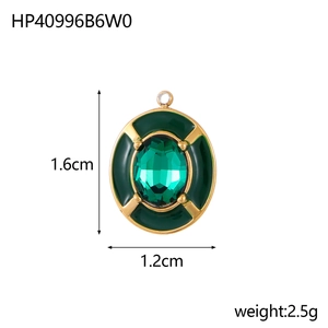 Macro view of oval gold pendant with green enamel and zircon inlay showing 1.6cm dimensions