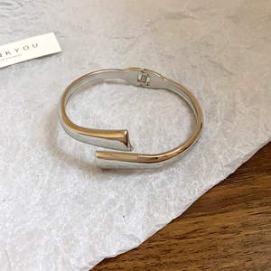 Detailed view of silver minimalist hinged cuff bracelet with flat geometric rectangle ends