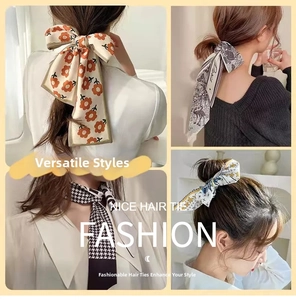 Detail of four patterned silk hair scarves including floral, houndstooth, and star prints