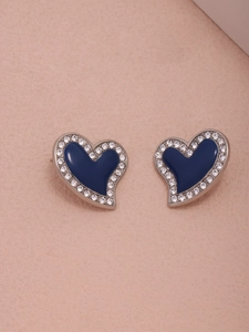 Detail of silver heart earrings with deep blue enamel and sparkling crystal border