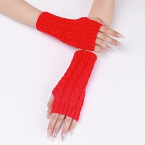 Close-up of red cable knit fingerless gloves with stylish braided texture and hand detail