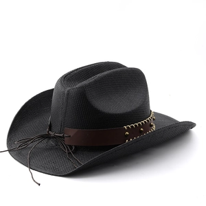 Detail of black straw cowboy hat featuring brown leather band and metallic rivets