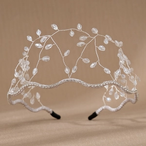 Detail of handmade crown headband with leaf-shaped crystal beads and silver wire