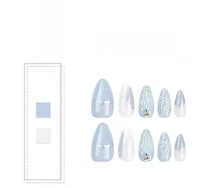 Detail of almond-shaped press-on nails with blue shell texture and glitter accents