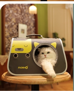 Macro view of portable cat carrier with mesh window and cute cartoon pattern on fabric