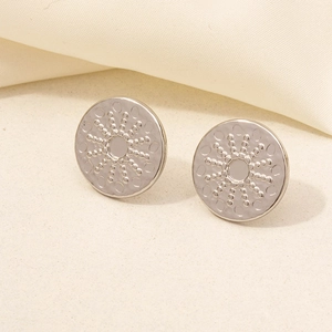 Close-up of 304 stainless steel stud earrings with embossed radial starburst texture