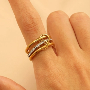 Detail of multi-layer gold stacked ring with micro-paved white zircons on ring finger