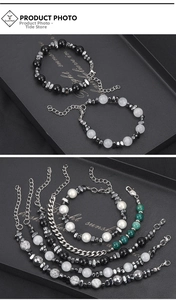 Detail of beaded hematite and titanium steel bracelets with lobster clasp and chain link